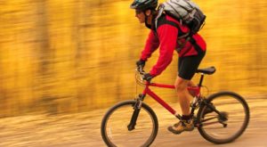 man with a backpack biking