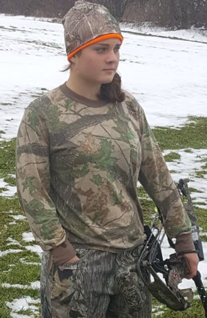 Camouflaged girl holding a hunting bow