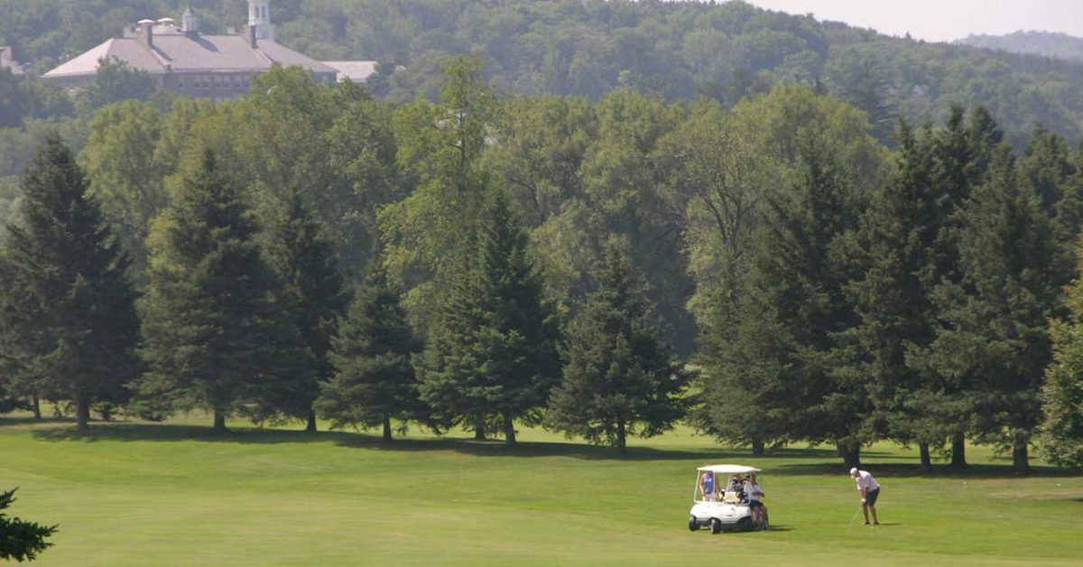 Golfing next to a golf cart