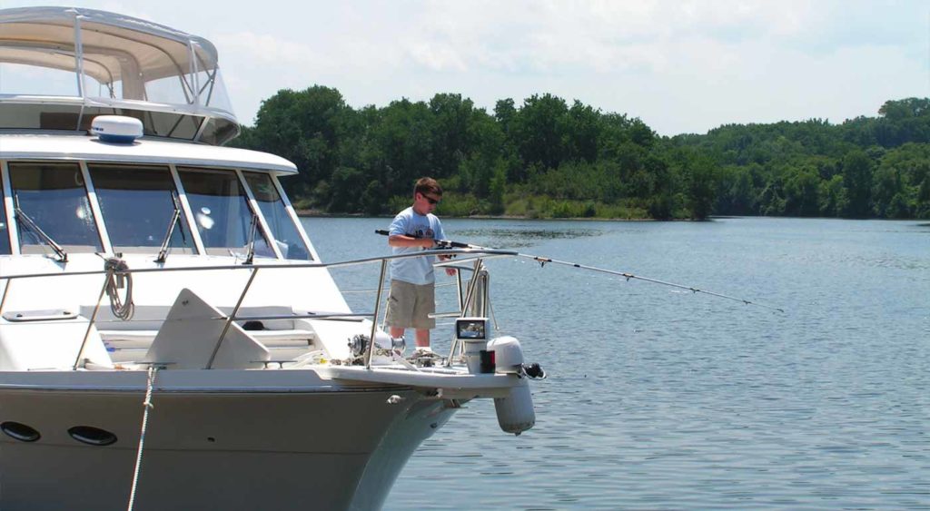 Kid fishing from the bow of a boat