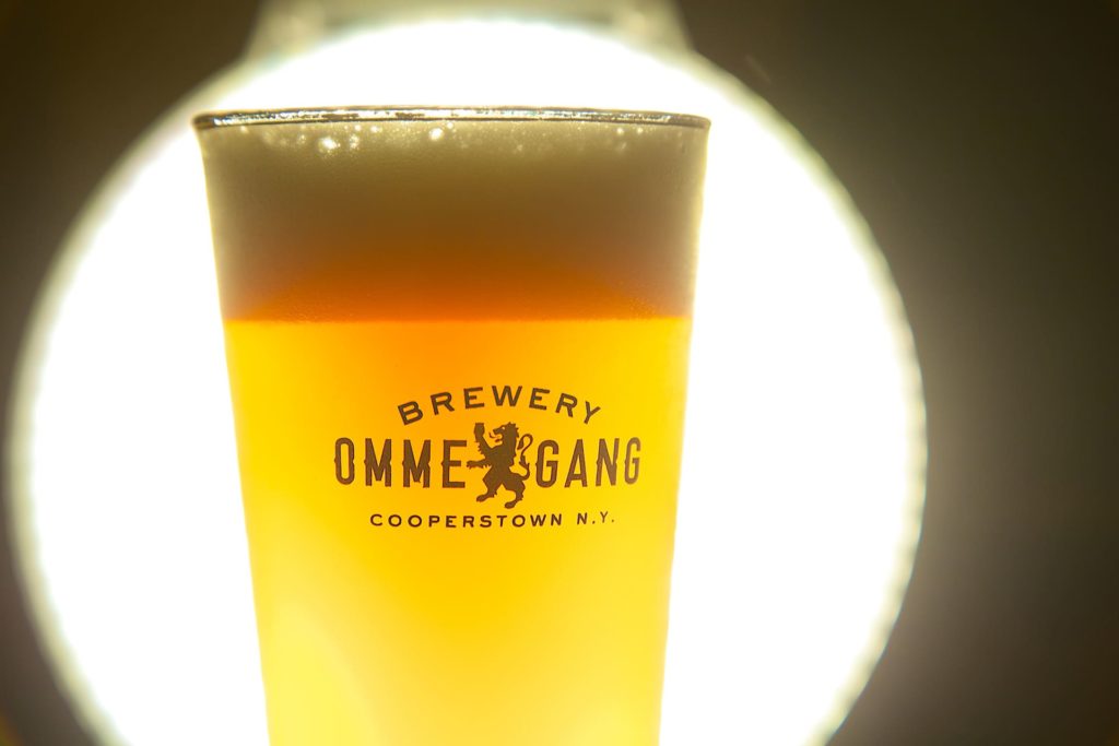 Ommegang pint glass full of beer