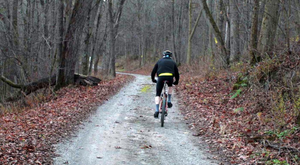 Person biking down a trail