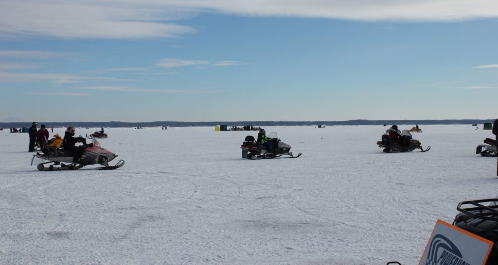 Snowmobiles driving on ice