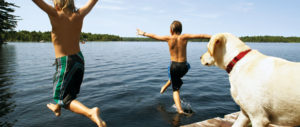 Boys and their dog jumping into Oneida Lake