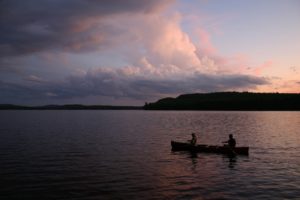 People fishing from their canoe