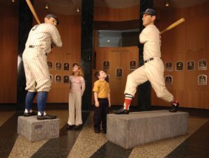 Kids looking at baseball player statues