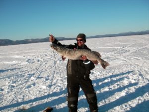 Man holding a pike from ice fishing