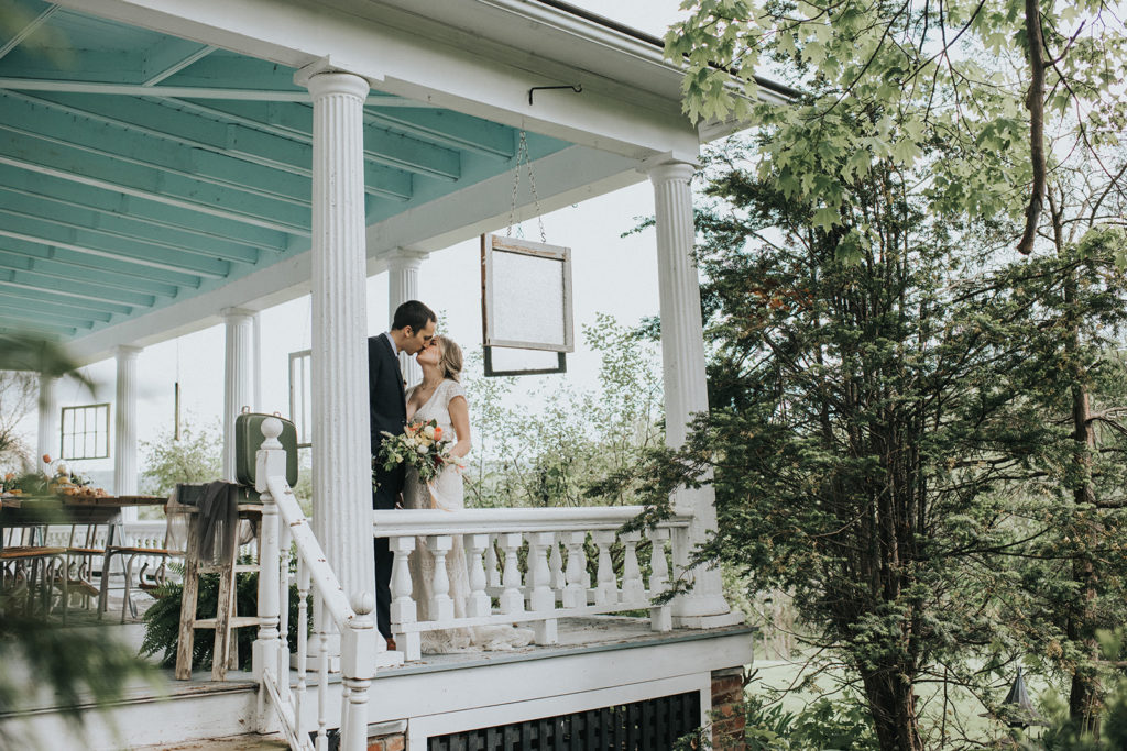 A married couple kissing on the Veranda