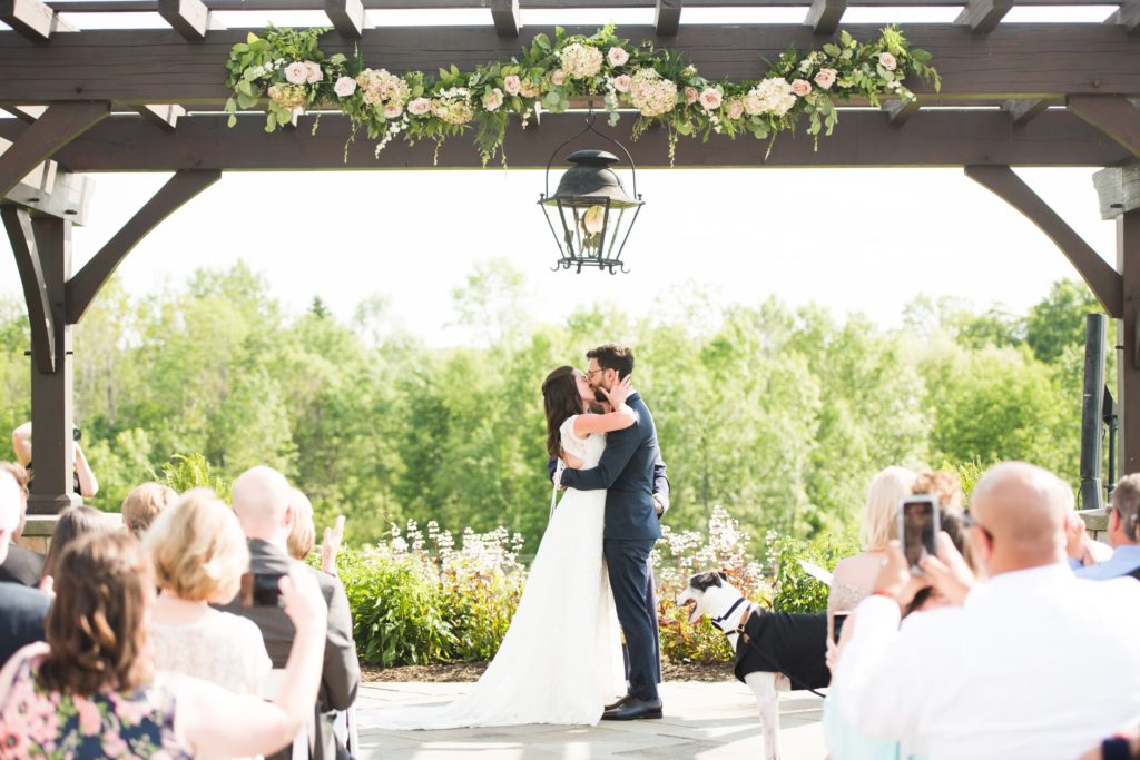 A couple kissing at their wedding