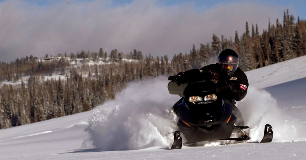 snowmobile driving through a field