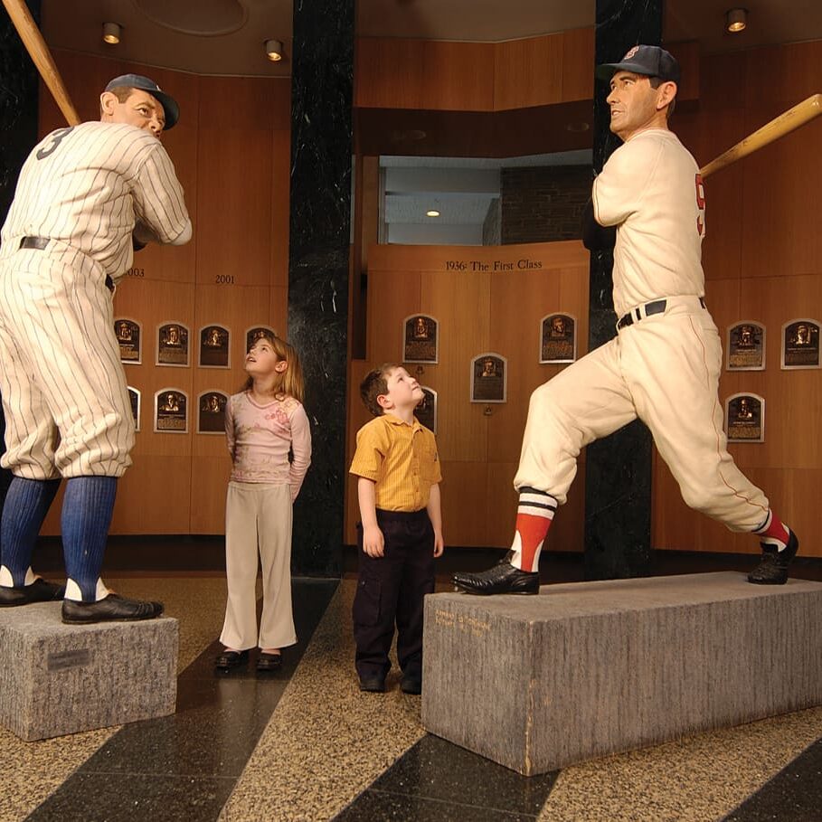 Kids looking at baseball player statues